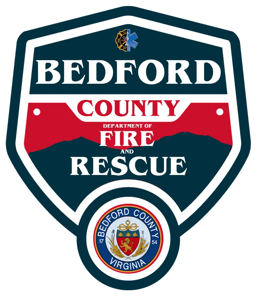 A shield-shaped emblem for Bedford County Department of Fire and Rescue. The top section says "Bedford" in white, then "County" in red below. Underneath is "Department of Fire and Rescue." The bottom features the Bedford County Virginia seal.