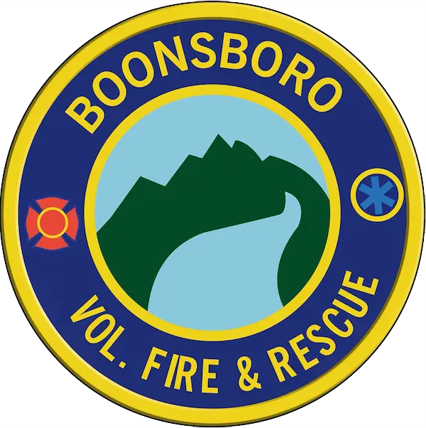 A circular emblem with a blue background featuring a mountain and river scene in the center. Text around the edge reads "BOONSBORO VOL. FIRE & RESCUE." The emblem also includes a fire symbol and a star of life symbol on either side of the central image.